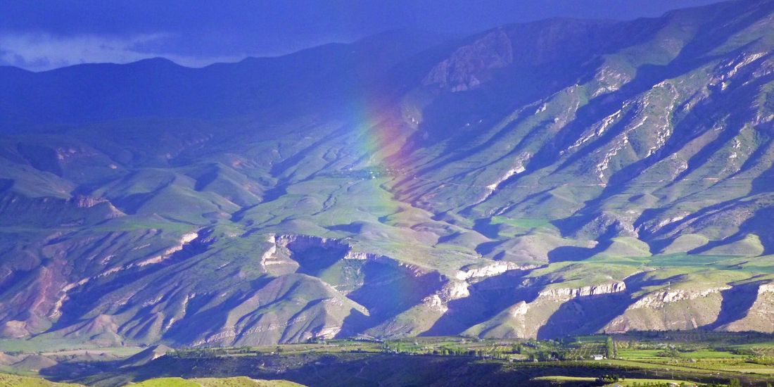 Rainbow over the mountain slopes above Aghavnadzor after a storm, Vayots Dzor